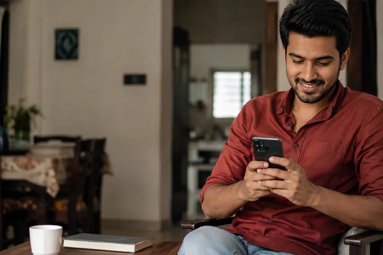 Indian borrower exploring loan options on a phone at home